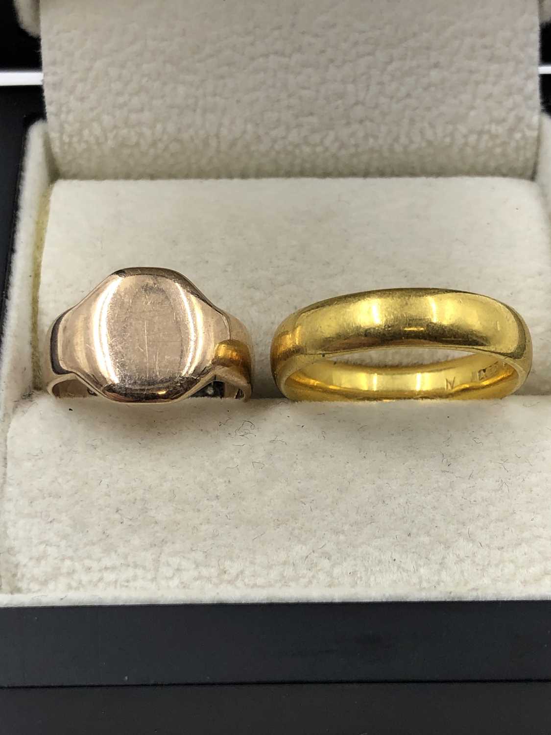 Lot 1047 - Two gold rings. A 22ct gold wedding ring, size...