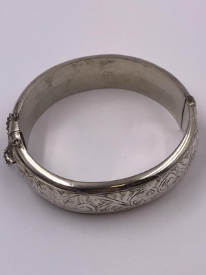 Lot 1037 - Three vintage hallmarked silver hinged bangles.
