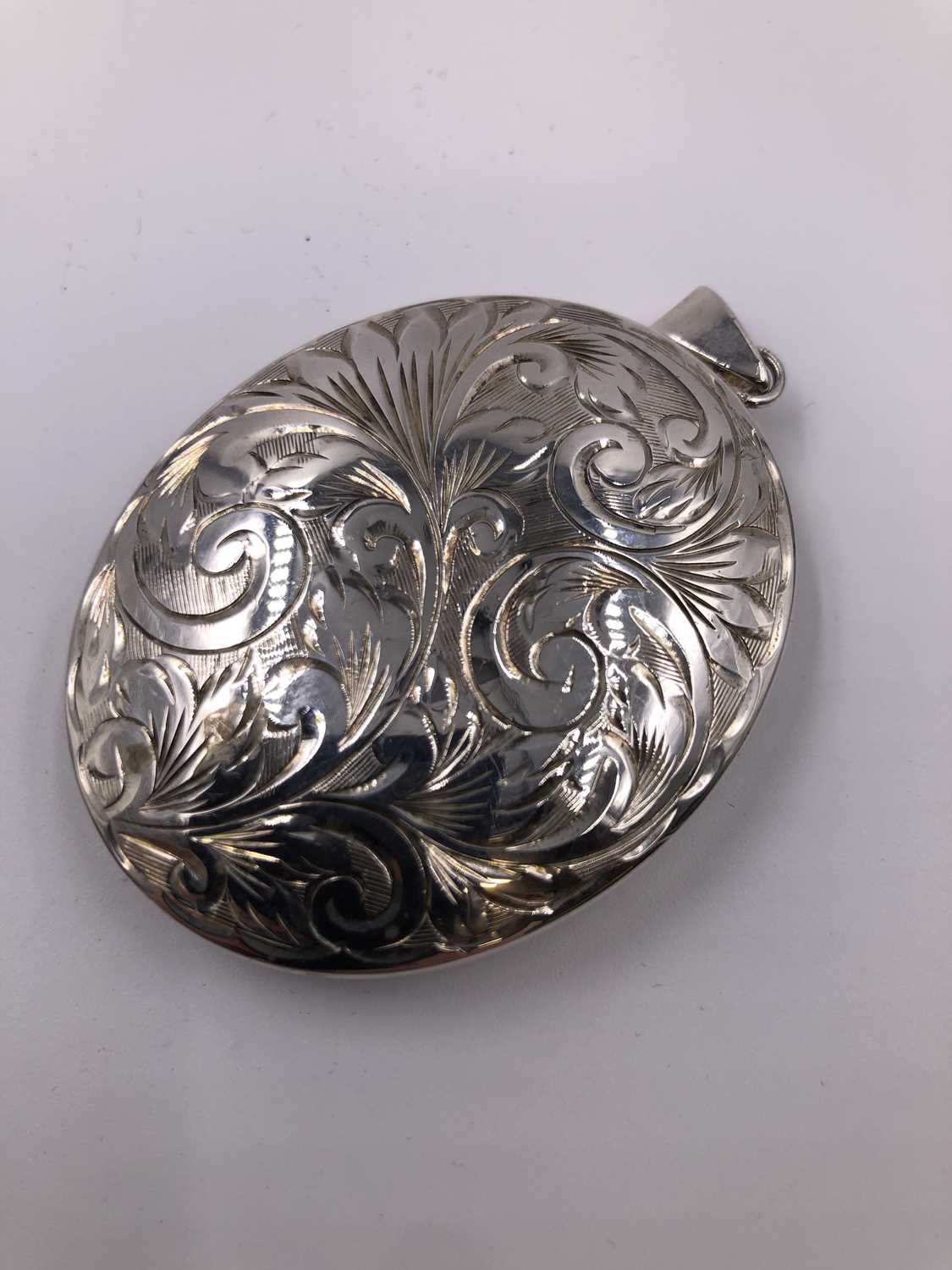 Lot 1005 - A large hallmarked silver engraved portrait...