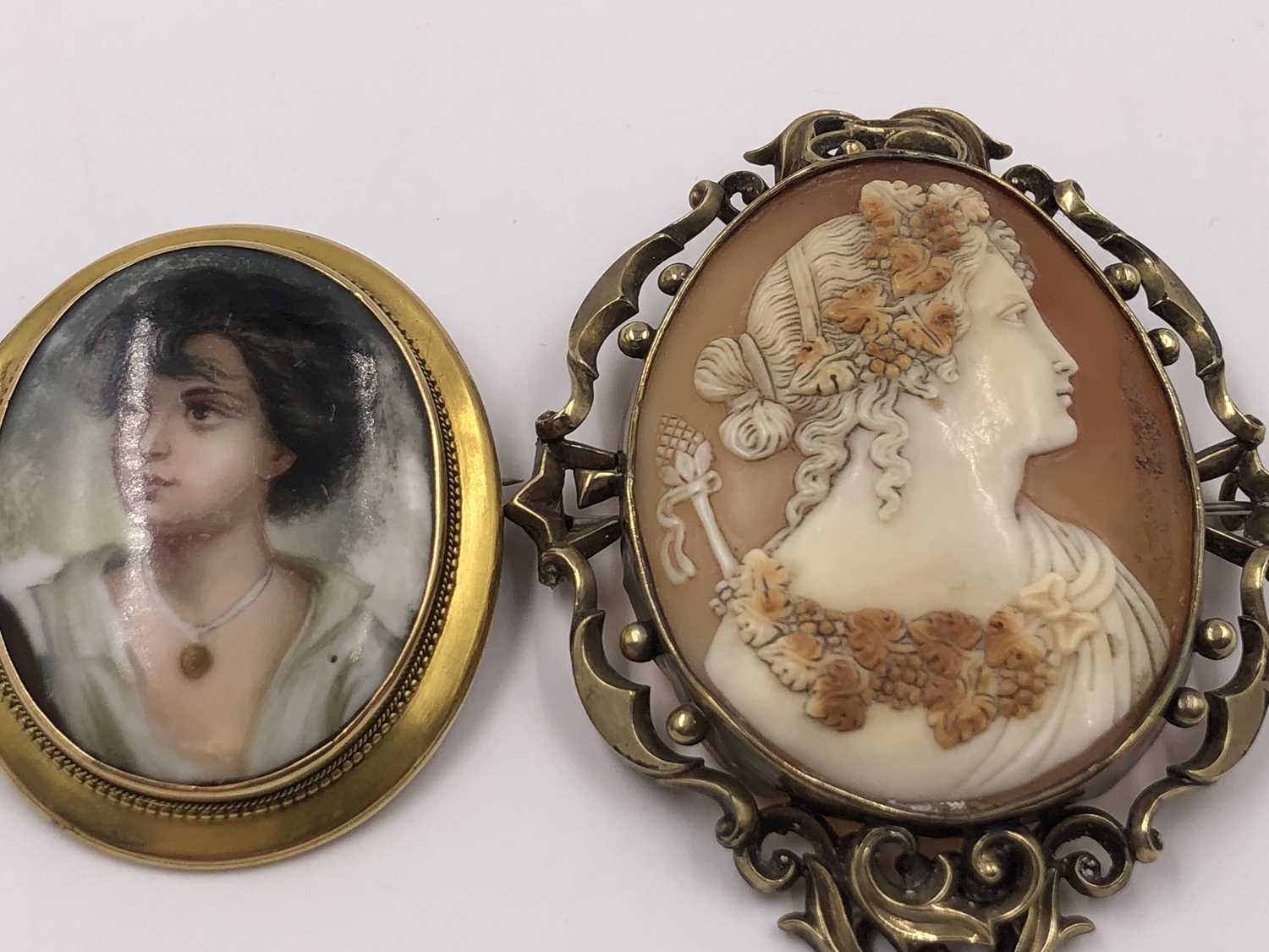 Lot 1035 - A porcelain and gold portrait brooch,...