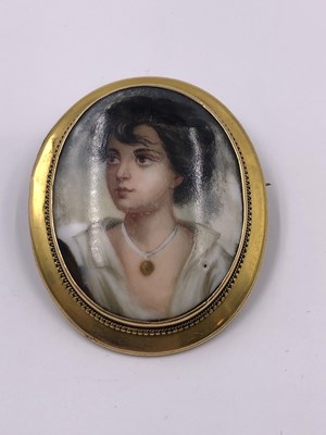 Lot 1035 - A porcelain and gold portrait brooch,...