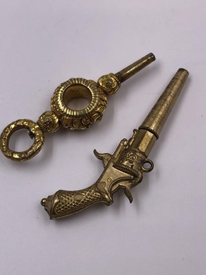 Lot 1017 - An antique miniature pistol clock key and one...