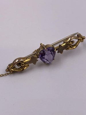 Lot 1013 - An antique gem set heart cut 9ct gold bar...