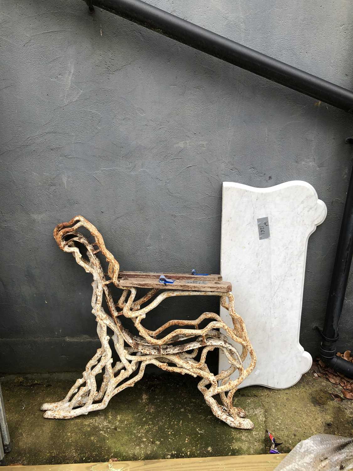 Lot 1261 - A pair of large antique cast iron bench ends...