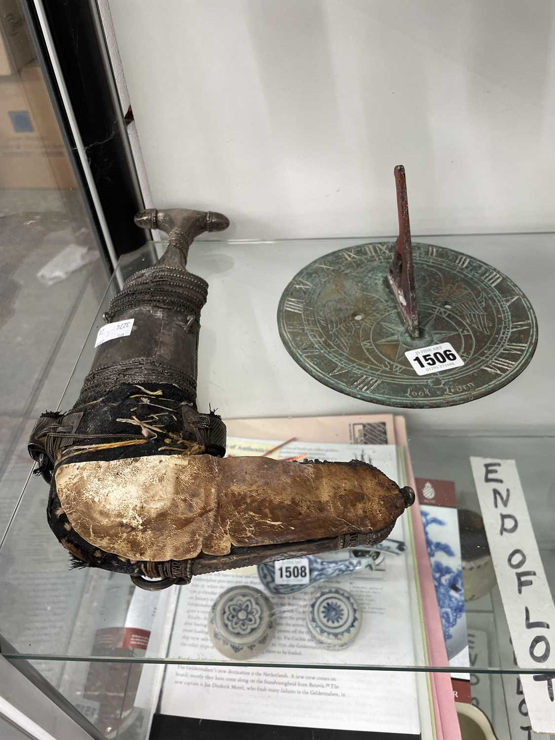 Lot 1506 - An Arabian dagger together with a bronze sundial