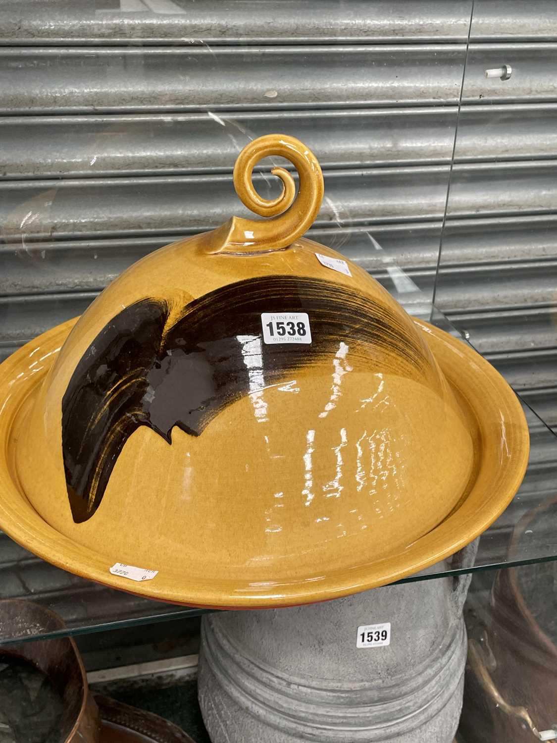 Lot 1538 - A studio pottery yellow ground cheese bell...
