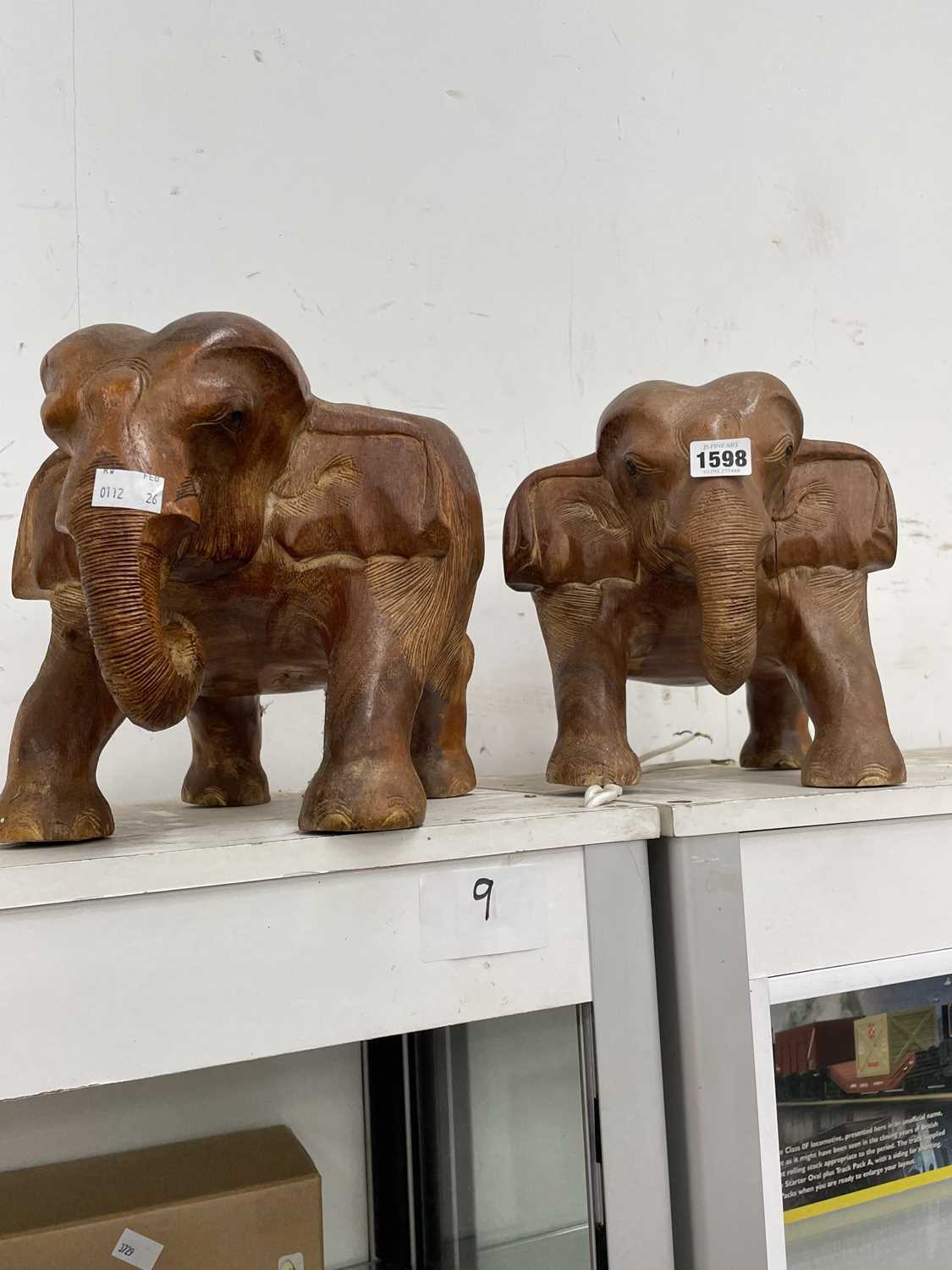 Lot 1598 - A pair of carved wood elephant figures