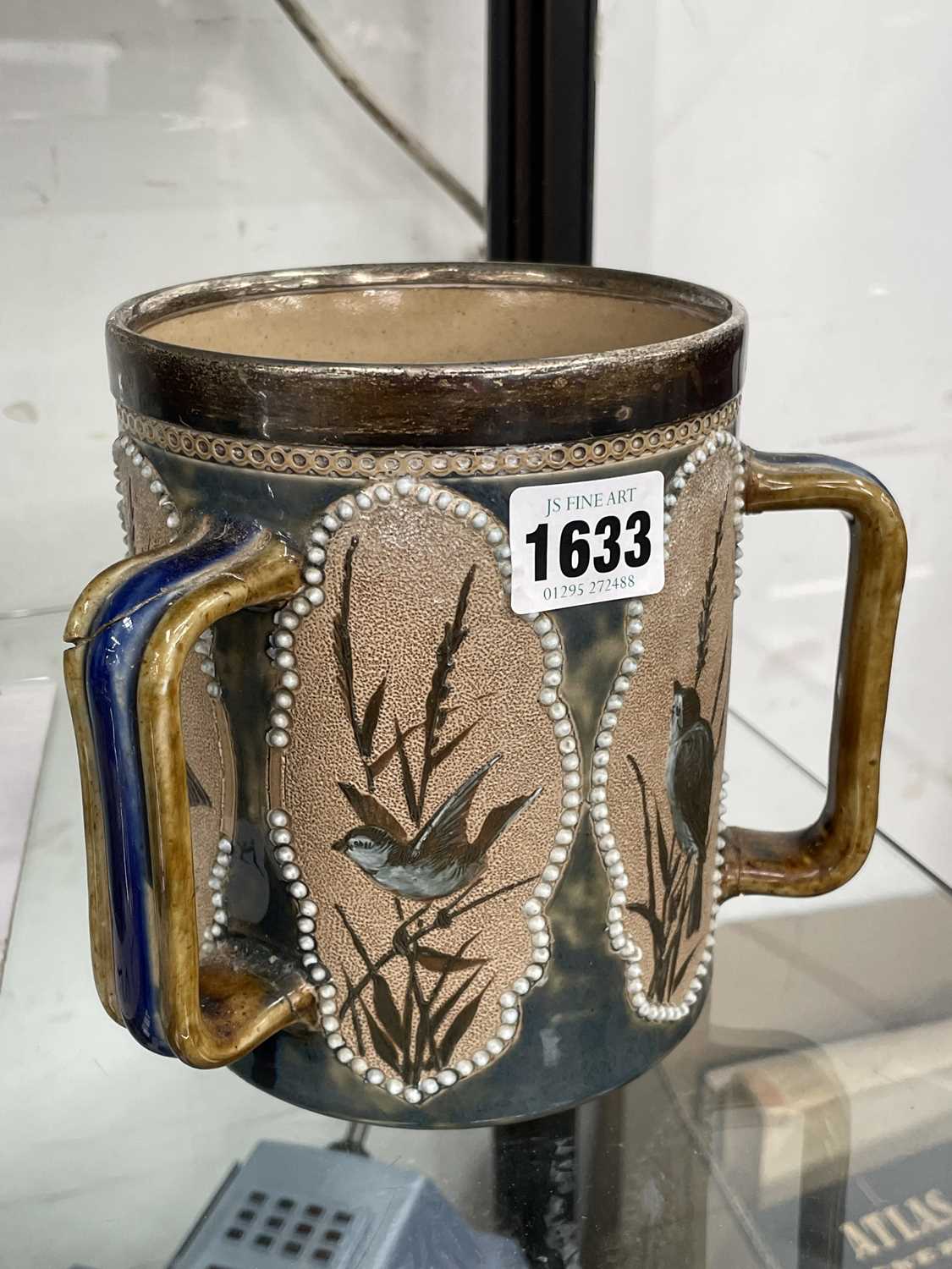 Lot 1633 - A silver rimmed Doulton Tyg decorated by...
