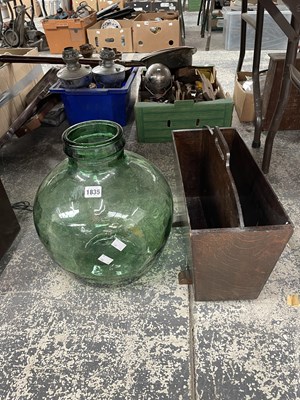 Lot 1835 - A glass demijohn together with a magazine rack