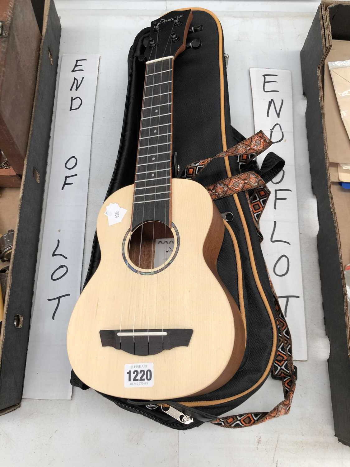 Lot 1220 - A Donner mini acoustic guitar with case.