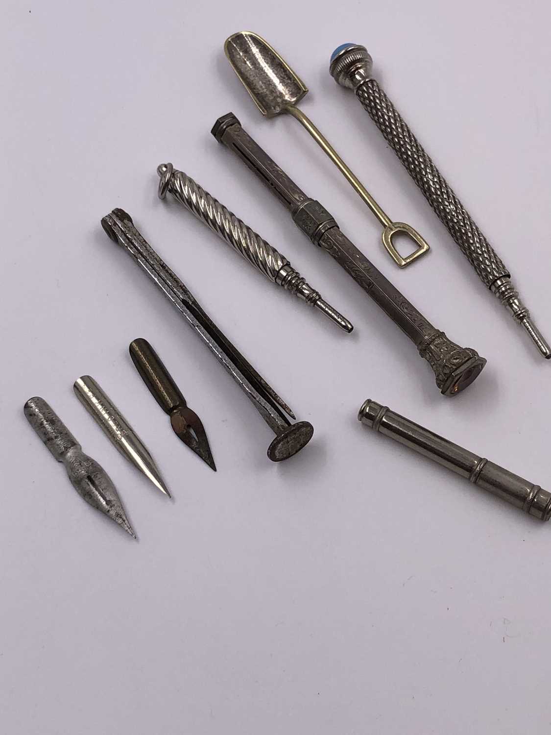 Lot 1021 - A continental silver propelling pencil, two...