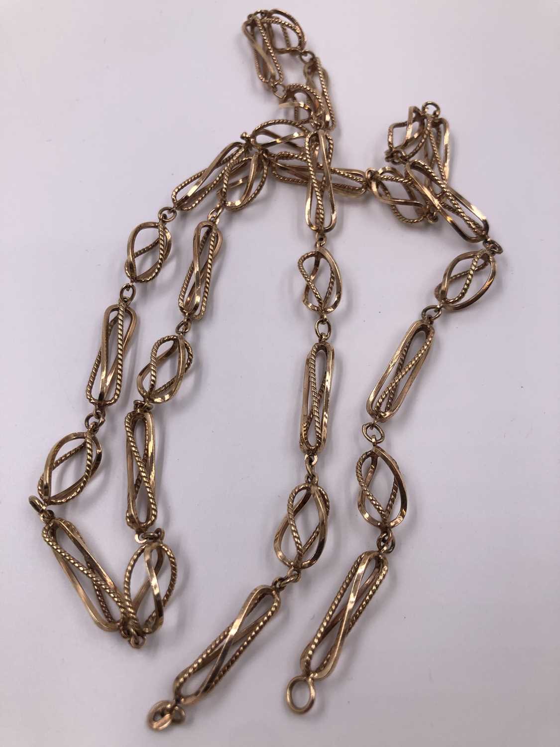 Lot 1011 - A 9ct hallmarked gold fancy link open-work...