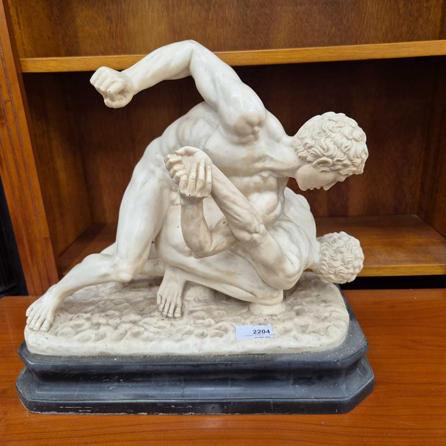Lot 2204 - A cast figure of wrestlers after the antique.L...