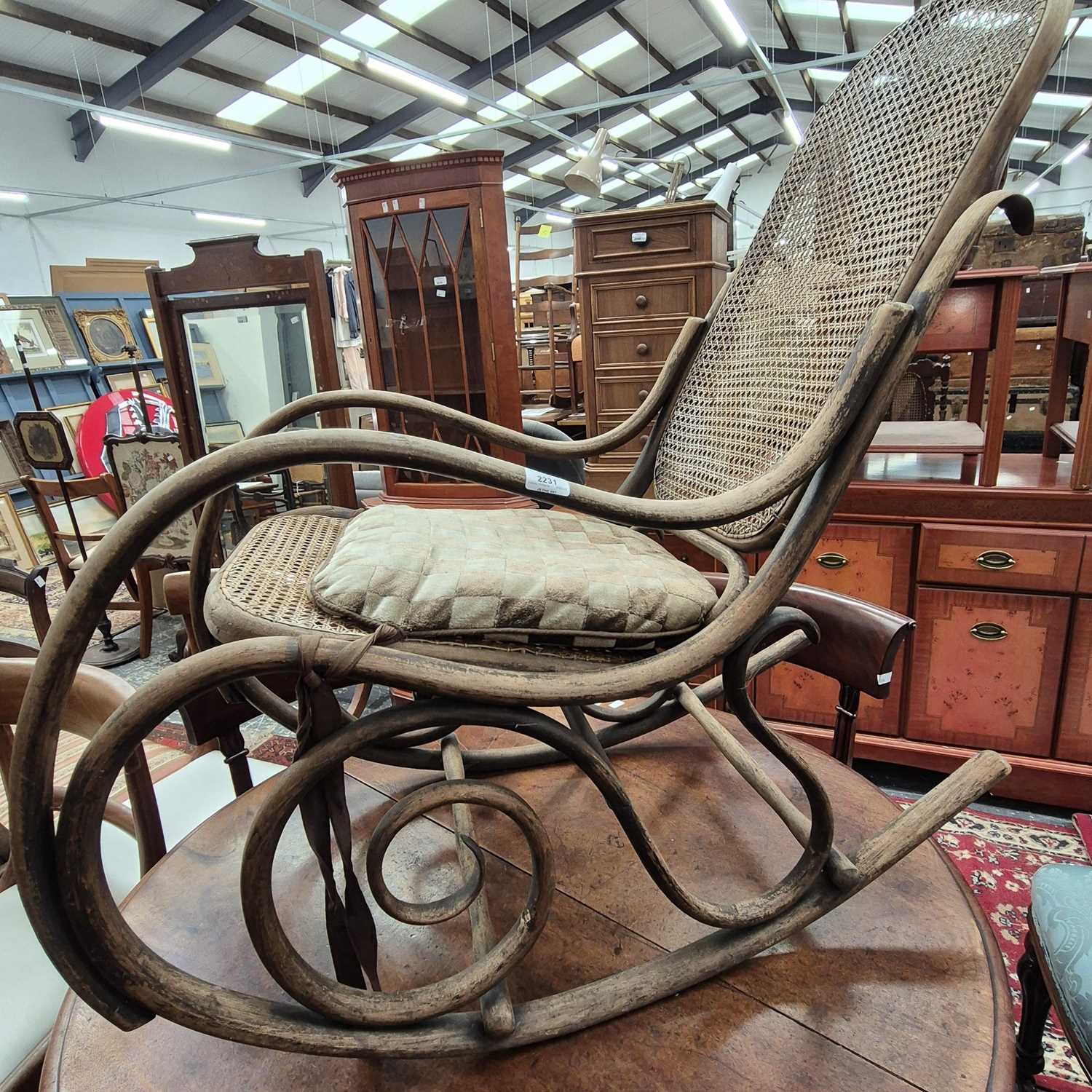 Lot 2231 - An antique Bentwood framed rocking chair with...