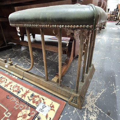 Lot 2246 - An antique leather-topped brass club fender....
