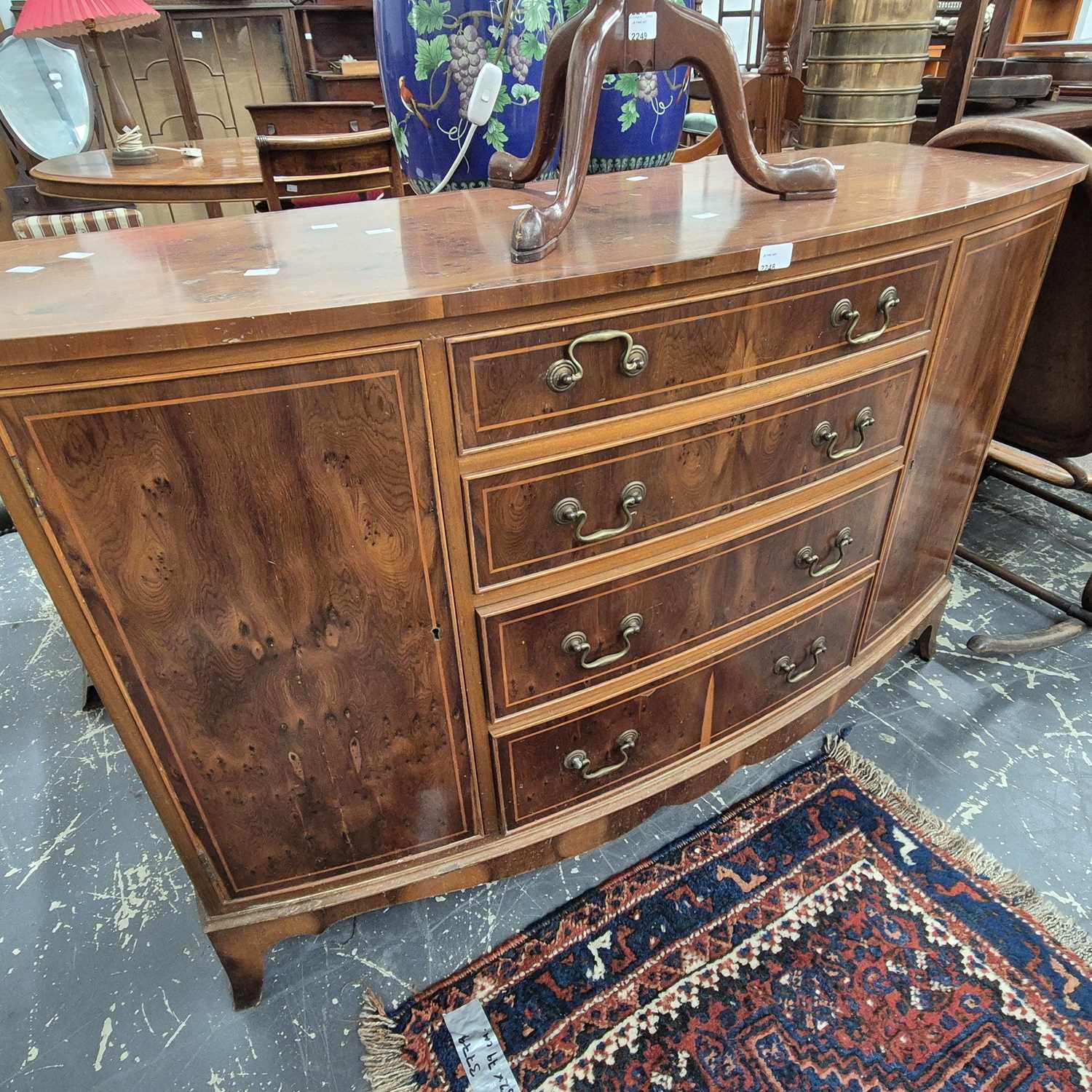 Lot 2248 - A Georgian style yewwood bow-front sideboard.