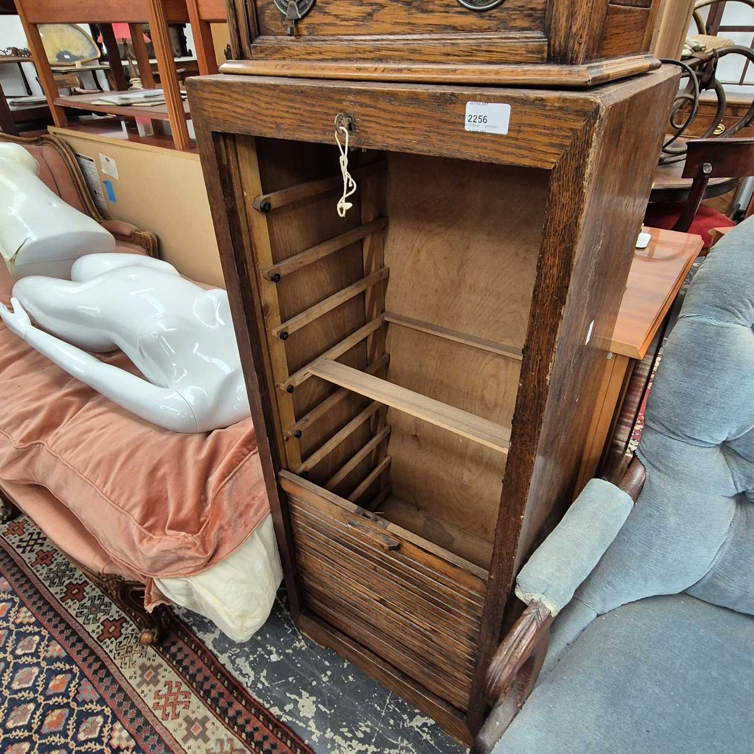Lot 2256 - An oak tambour front cabinet.