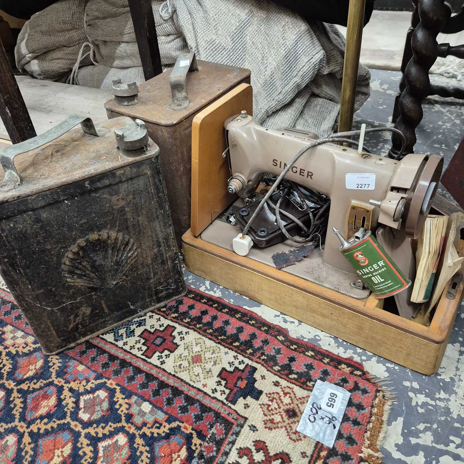 Lot 2277 - A sewing machine, and two fuel cans.