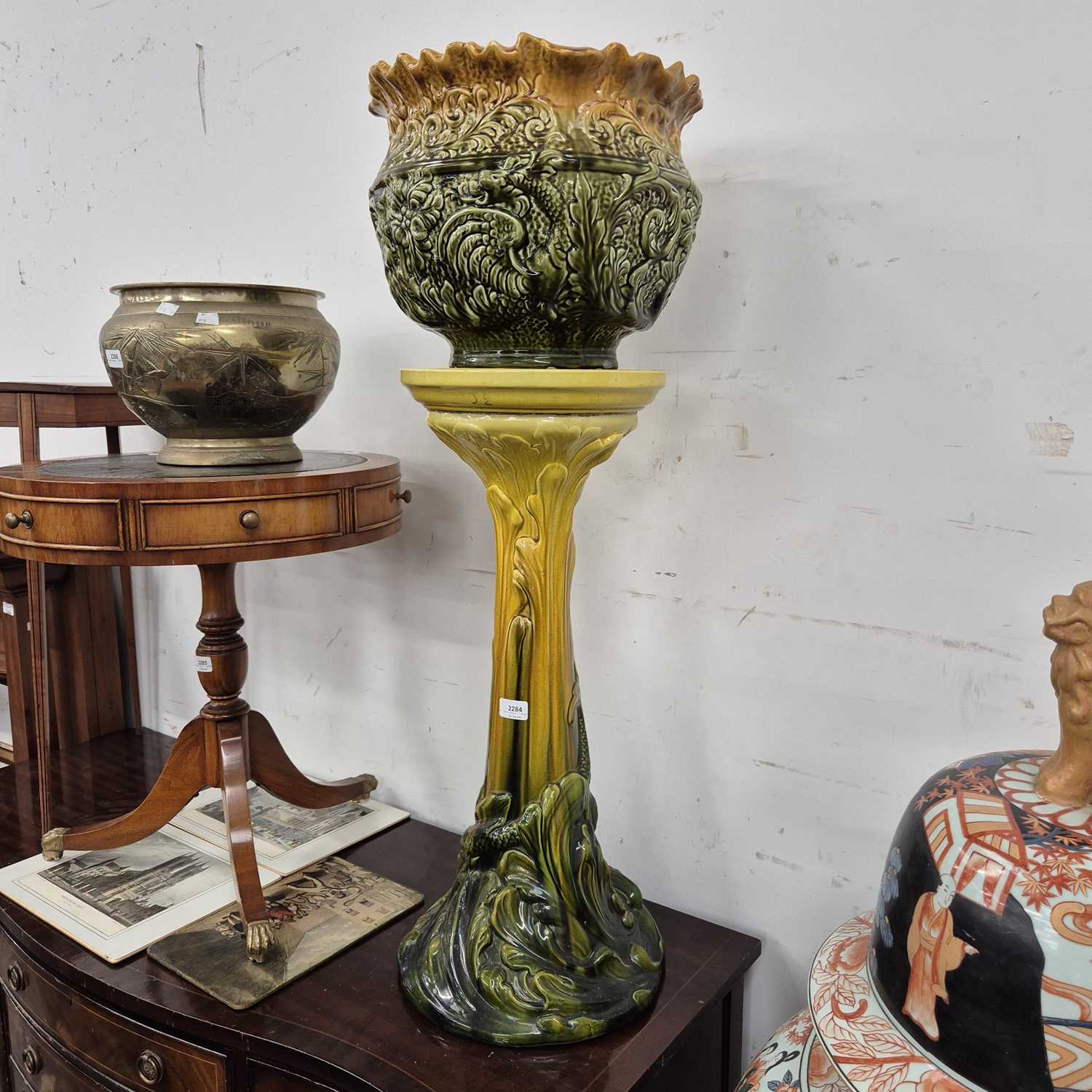 Lot 2284 - A Bretby pottery jardiniere stand and an...