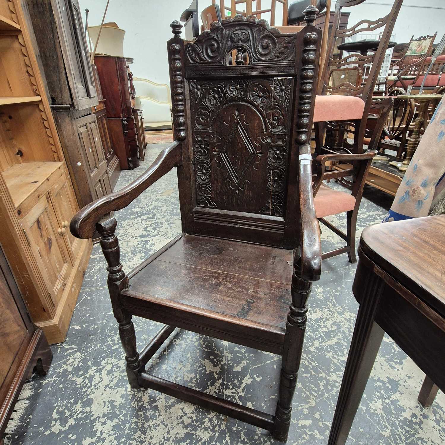 Lot 2560 - An antique carved oak high-back Wainscott-type...