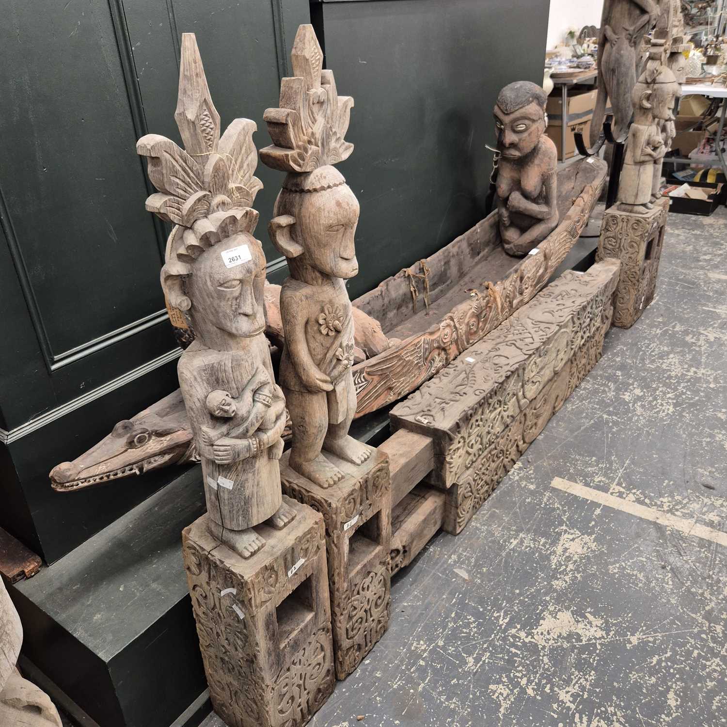 Lot 2631 - A pair of Indonesian offering posts with four...