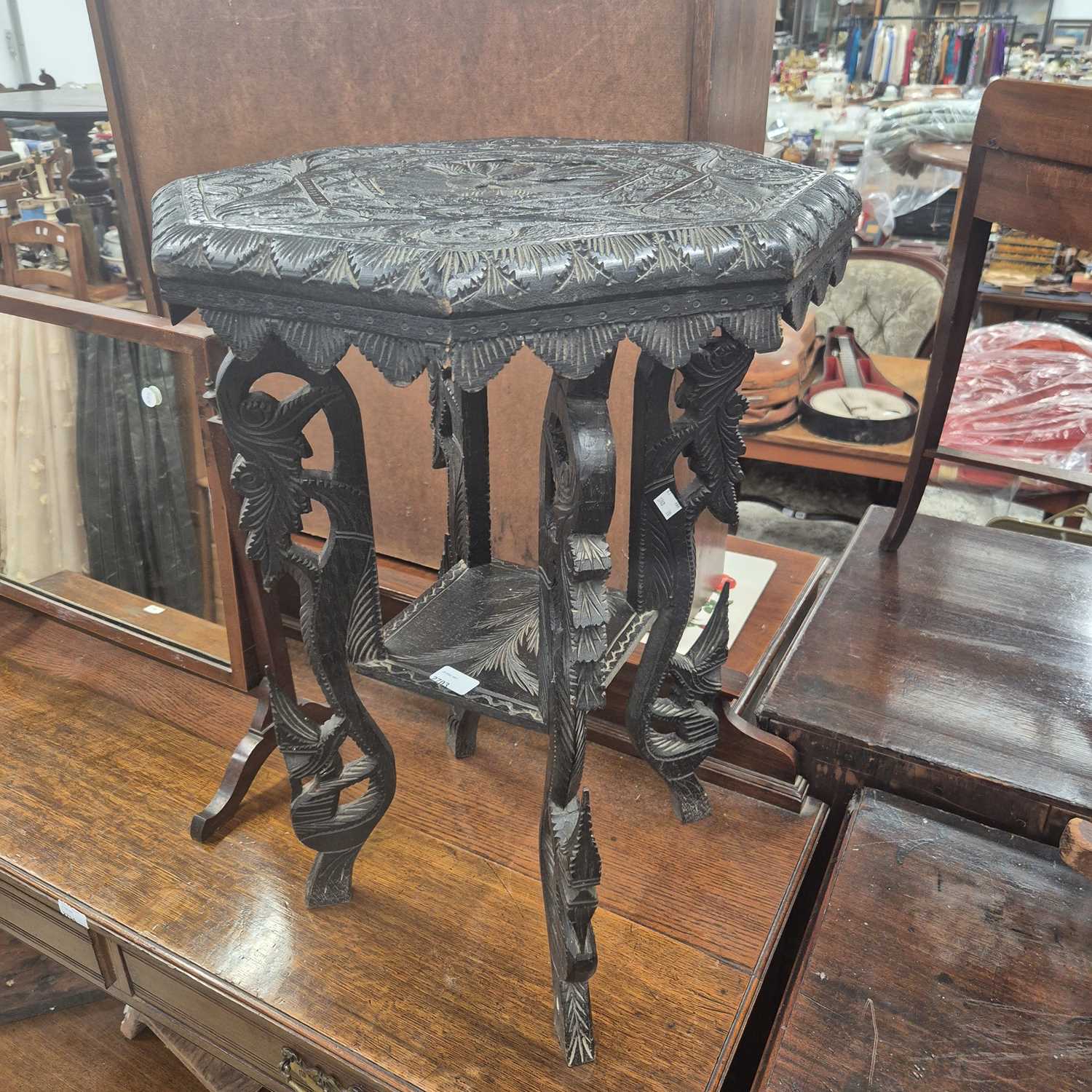 Lot 2703 - An ebonised occasional table.