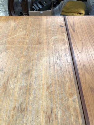 Lot 2744 - A large retro teak dining table.