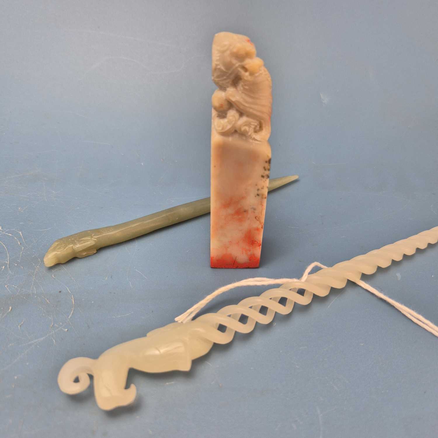 Lot 202 - A Chinese nephrite jade hair pin, the spiral...