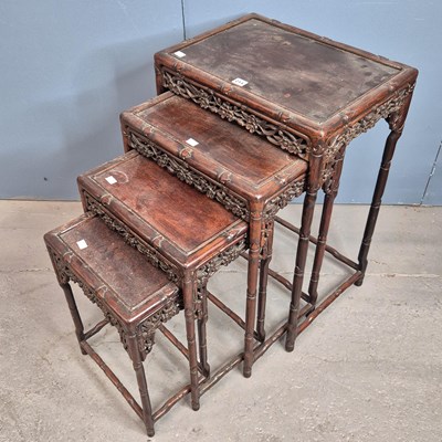 Lot 211 - A nest of four Chinese hardwood tables, each...