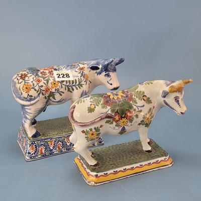 Lot 228 - Two 19th century polychrome Delft cows, each...