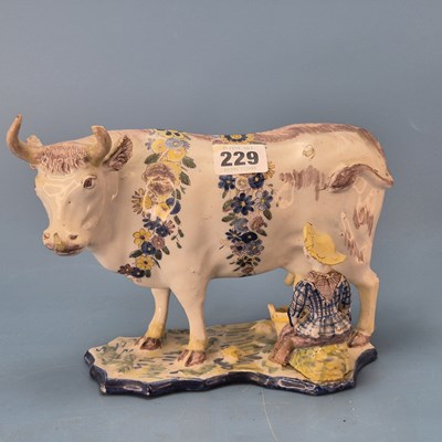 Lot 229 - A 19th century Dutch Delft polychrome cow and...