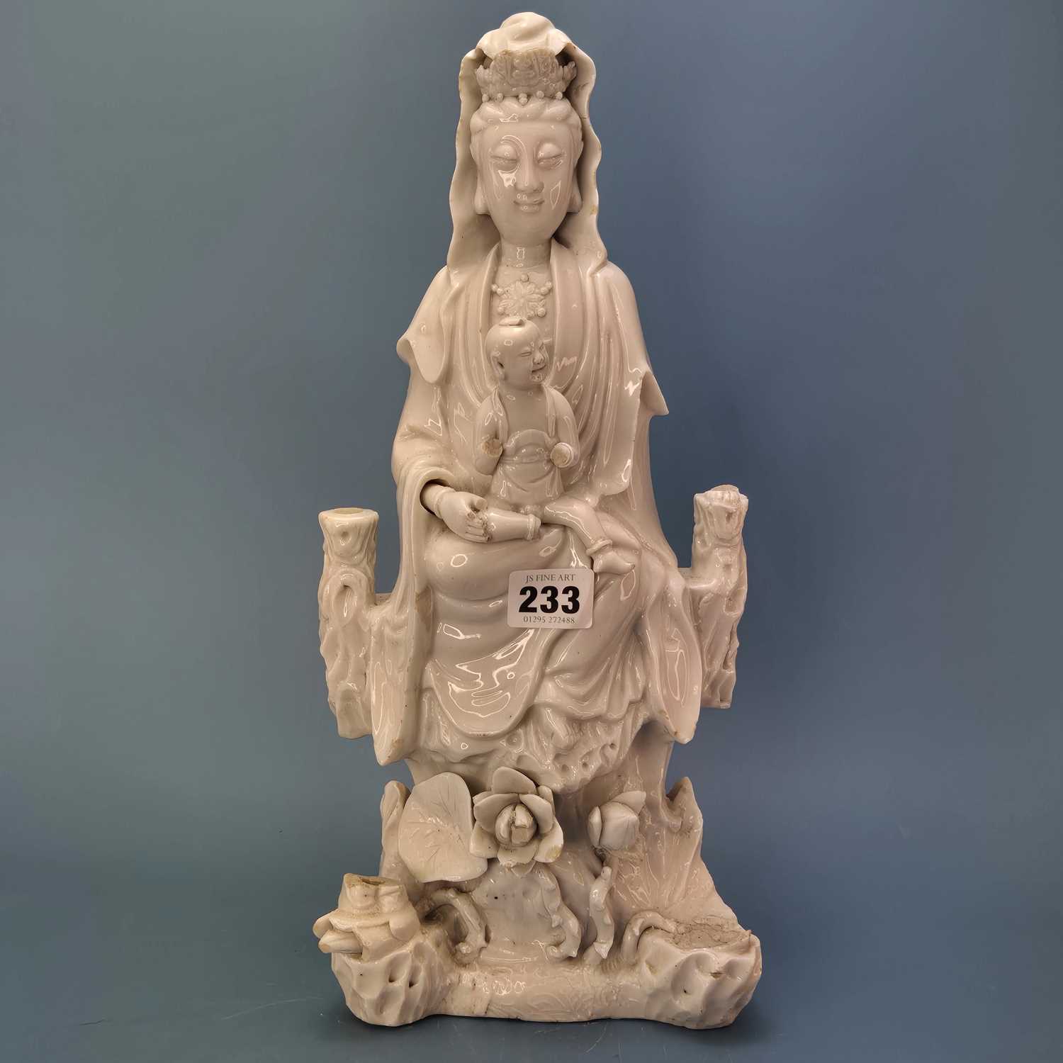Lot 233 - A blanc de Chine figure of Guanyin seated...