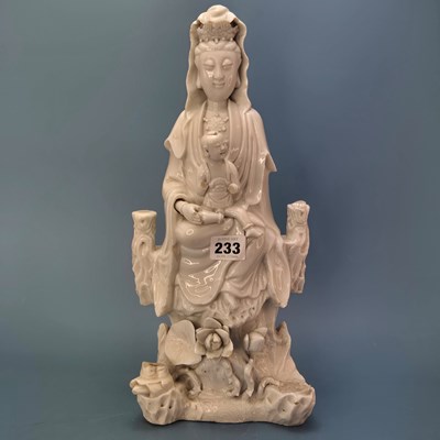 Lot 233 - A blanc de Chine figure of Guanyin seated...