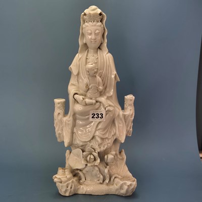 Lot 233 - A blanc de Chine figure of Guanyin seated...