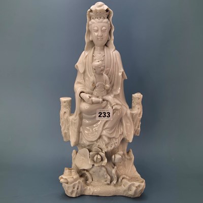 Lot 233 - A blanc de Chine figure of Guanyin seated...