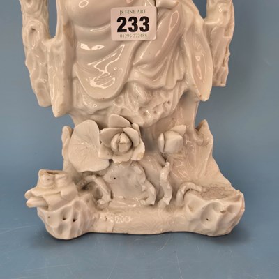 Lot 233 - A blanc de Chine figure of Guanyin seated...