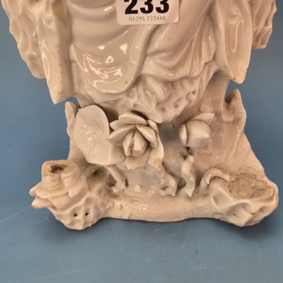 Lot 233 - A blanc de Chine figure of Guanyin seated...