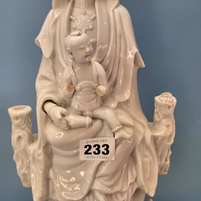 Lot 233 - A blanc de Chine figure of Guanyin seated...