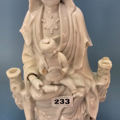 Lot 233 - A blanc de Chine figure of Guanyin seated...