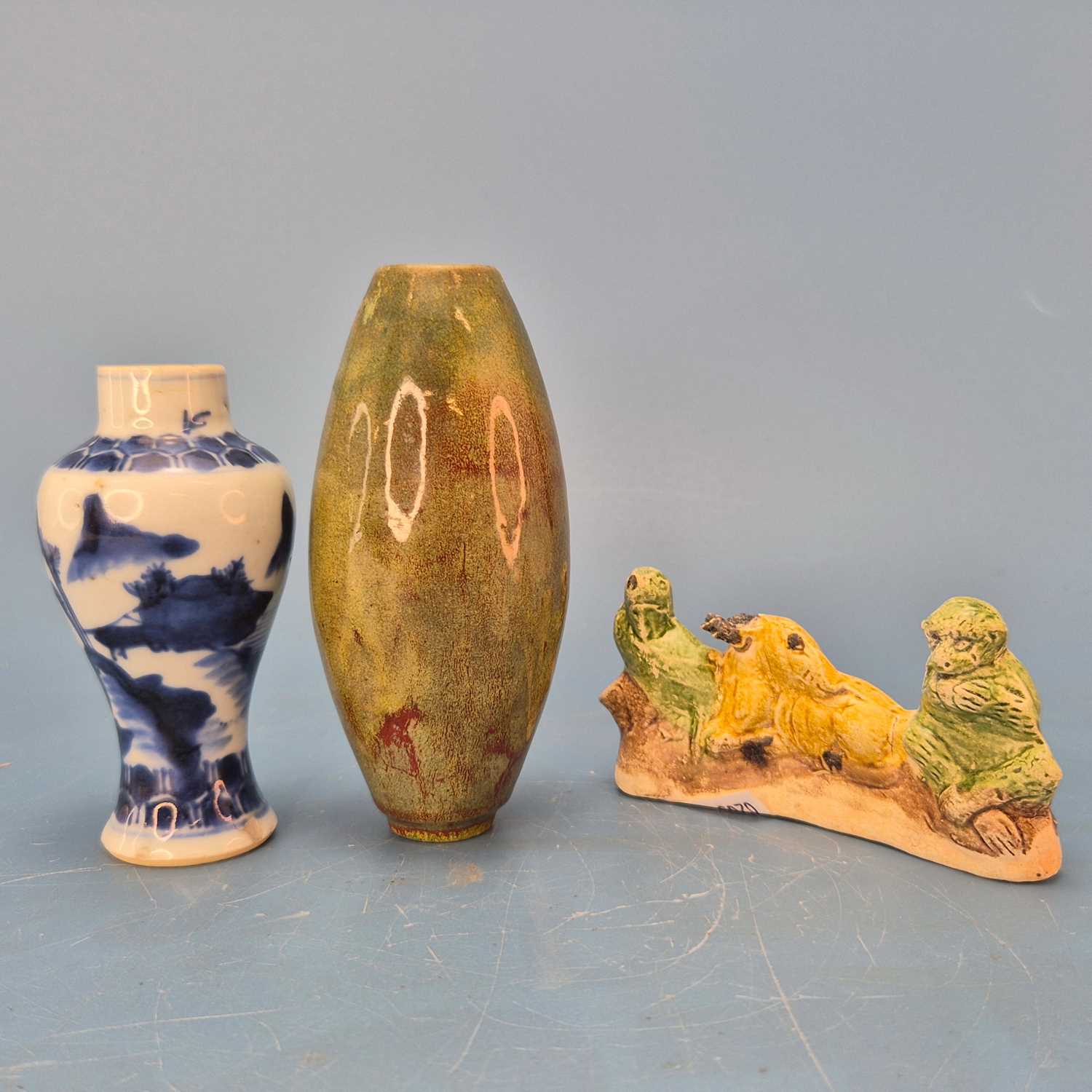 Lot 237 - A Chinese pottery brush rest in the form of a...