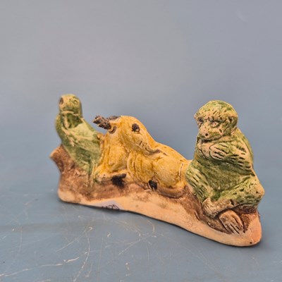 Lot 237 - A Chinese pottery brush rest in the form of a...