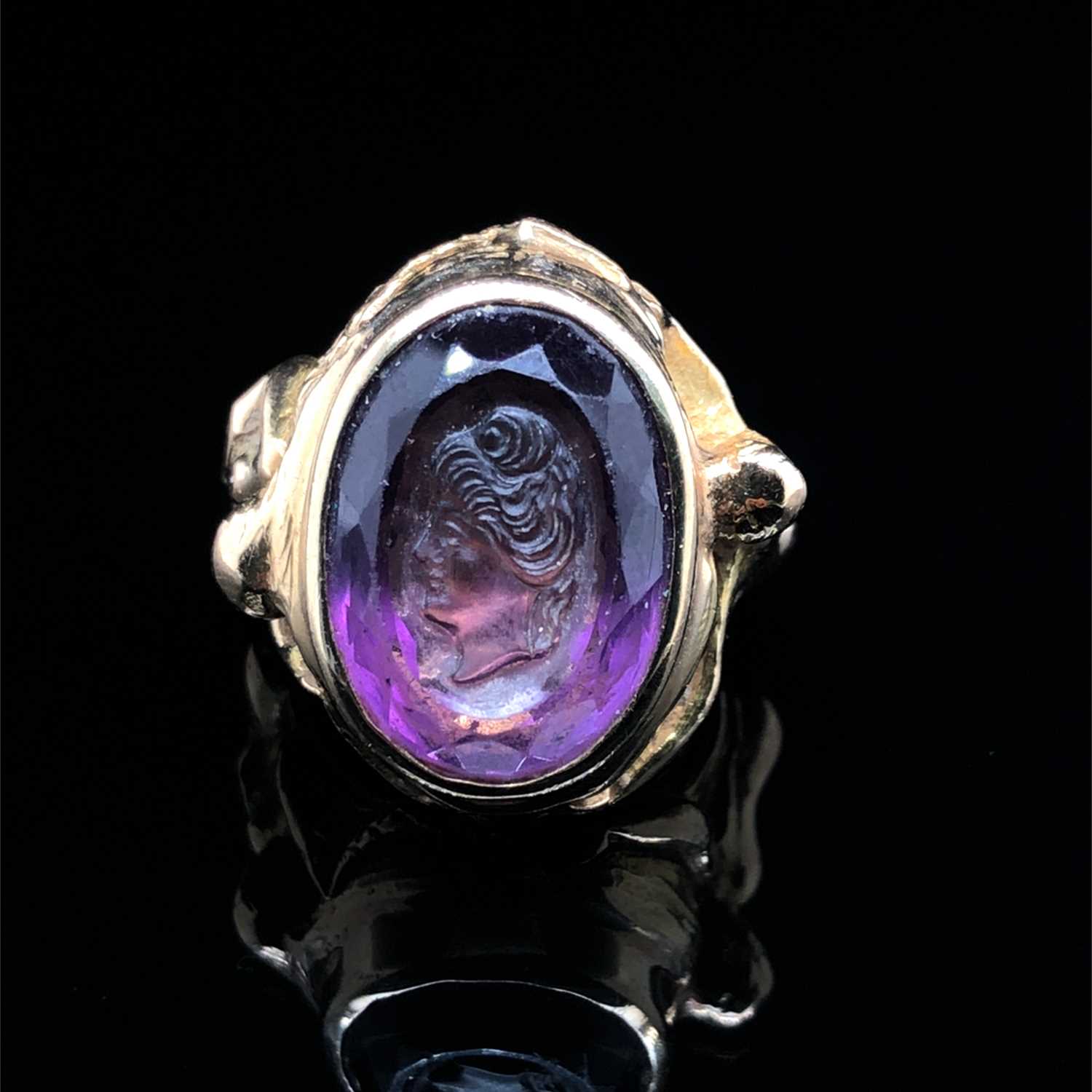 Lot 3 - A purple Facet cut & carved portrait cameo...