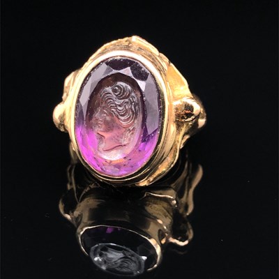 Lot 3 - A purple Facet cut & carved portrait cameo...