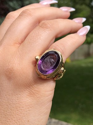 Lot 3 - A purple Facet cut & carved portrait cameo...