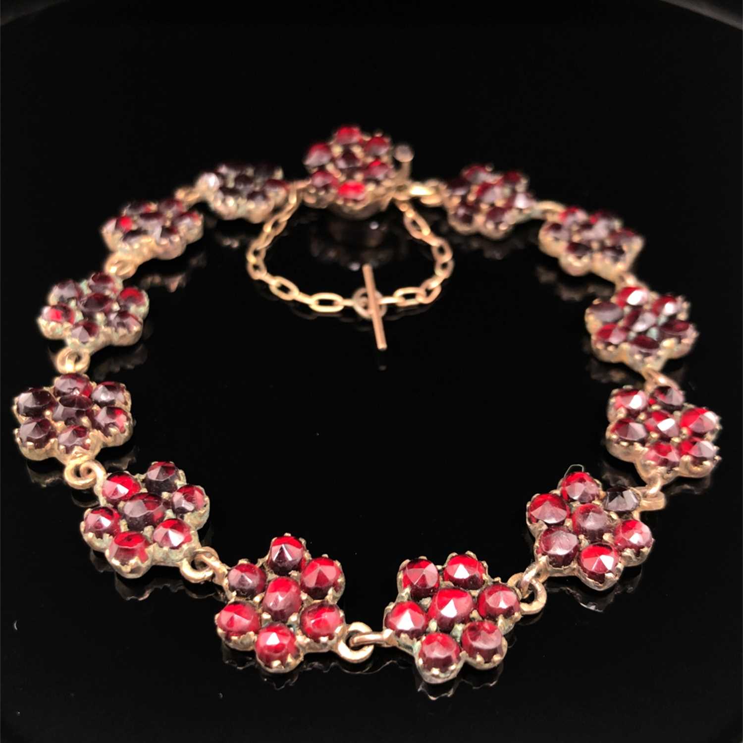 Lot 4 - A vintage garnet cluster panel bracelet. The...