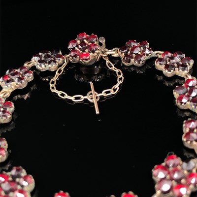Lot 4 - A vintage garnet cluster panel bracelet. The...