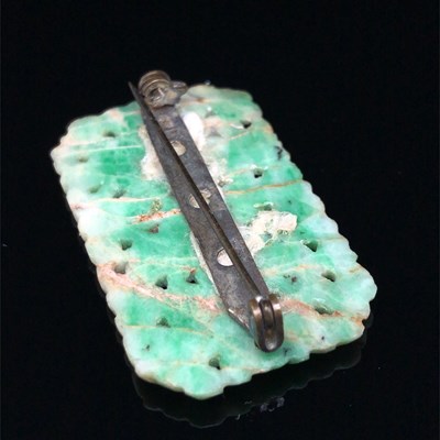 Lot 9 - An antique carved green jade brooch and four...