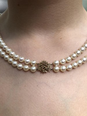 Lot 18 - A vintage double-strand uniform cultured pearl...