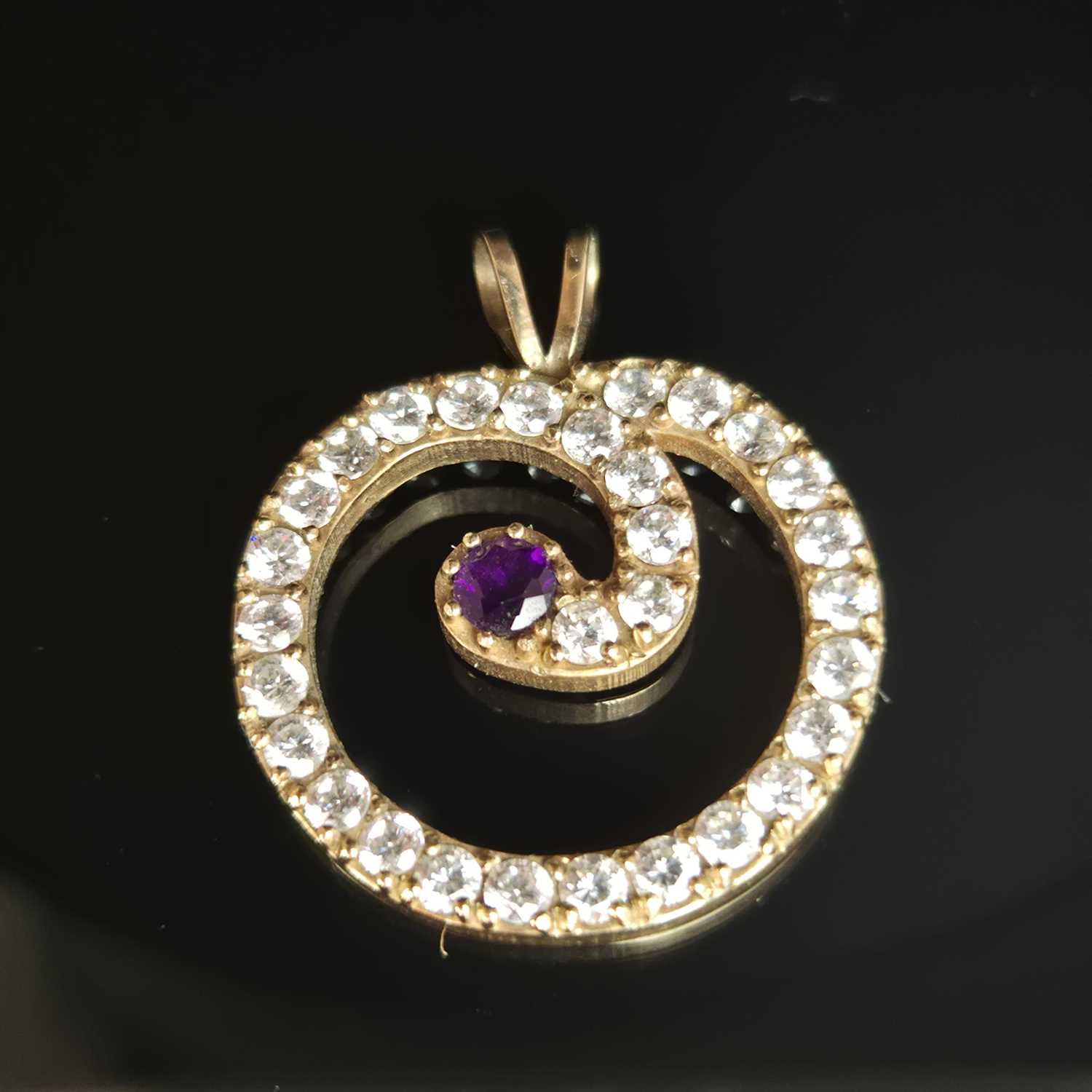 Lot 25 - A gemset and cz contemporary pendant....