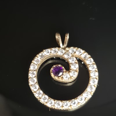 Lot 25 - A gemset and cz contemporary pendant....